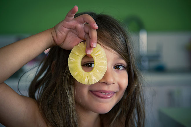 Image of young girl with pineapple